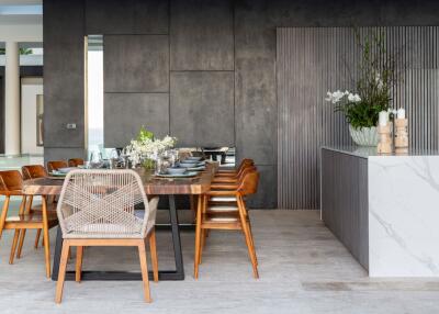 Modern dining area with a wooden table, stylish chairs, and decorative elements.