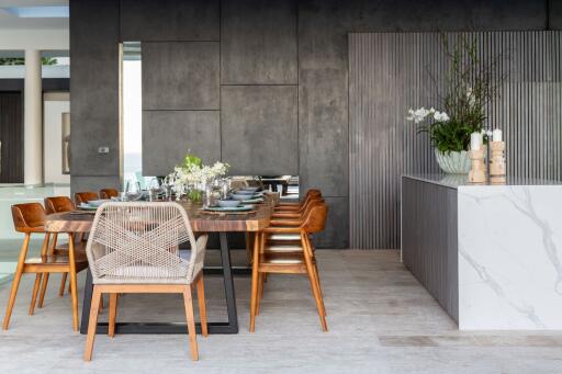 Modern dining area with a wooden table, stylish chairs, and decorative elements.