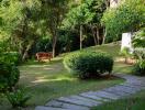 Lush garden with a wooden bench and stone pathway