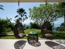 Outdoor patio with hanging chairs and ocean view