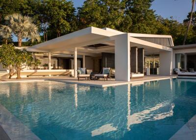 Modern outdoor view of a luxury villa with a large swimming pool