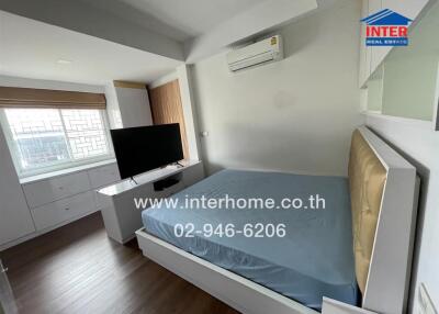 Bedroom with bed, TV, and air conditioner