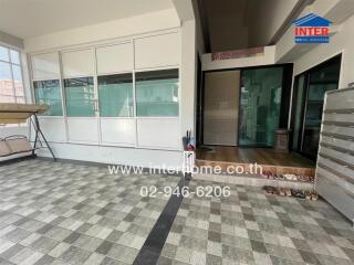 Entrance to the building with a tiled floor and shoe rack