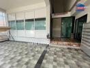 Entrance to the building with a tiled floor and shoe rack