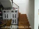 Staircase near dining area with storage cabinets