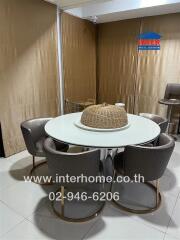 Modern dining area with a round white table and four comfortable chairs