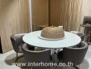 Modern dining area with a round white table and four comfortable chairs