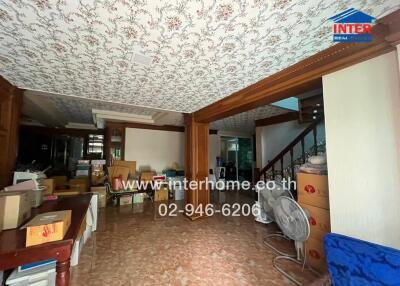 Spacious living area with patterned ceiling