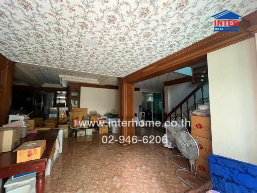 Spacious living area with patterned ceiling