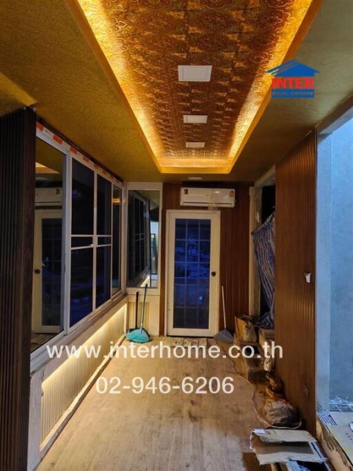 Long hallway with ceiling lights and construction materials