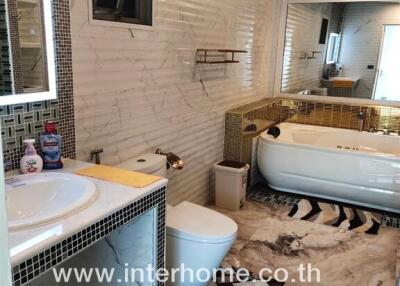 Modern bathroom with bathtub, sink, and decorative tiles