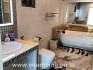 Modern bathroom with bathtub, sink, and decorative tiles