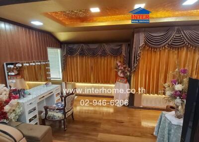 Living area with decorated curtains and wooden furnishings