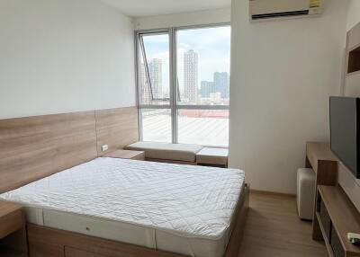 Bedroom with large window and city view