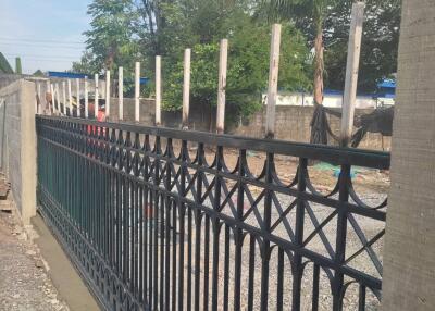 Outdoor construction with a black metal fence