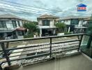 View from balcony overlooking residential neighborhood