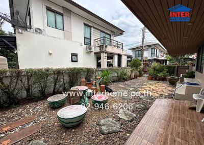 Outdoor seating area with decorative features and landscaping