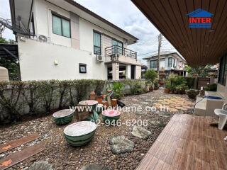 Outdoor seating area with decorative features and landscaping