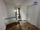 Hallway with wooden floor and white walls