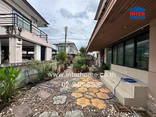 Well-maintained garden with pebbled flooring and a variety of plants