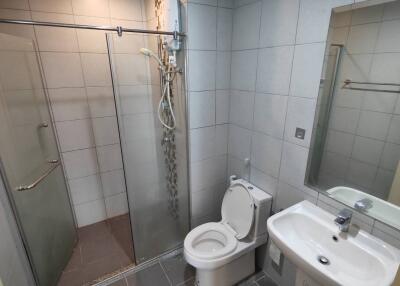 Modern bathroom with shower, toilet, and sink