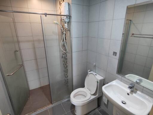 Modern bathroom with shower, toilet, and sink