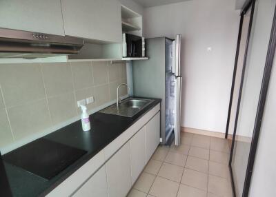 Modern kitchen with counter, sink, oven, and refrigerator