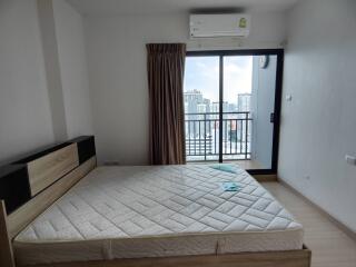 Bedroom with a large bed and a city view