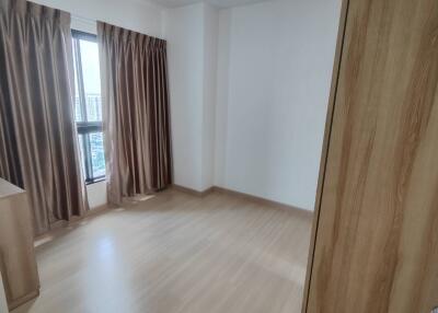 Empty bedroom with wooden floor and curtains