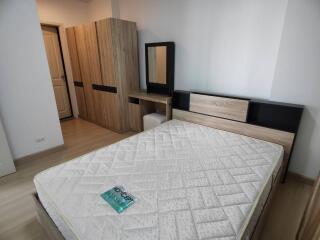 Modern bedroom with wooden furniture and a mattress