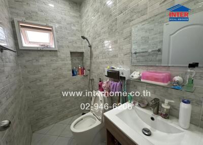 Bathroom with tiled walls and modern amenities