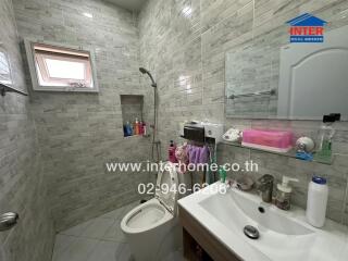 Bathroom with tiled walls and modern amenities