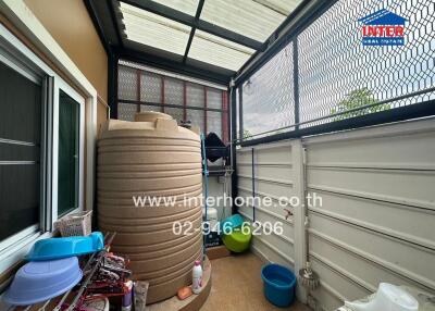 Covered exterior space with water tank and storage