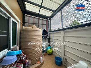 Covered exterior space with water tank and storage