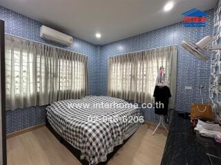 Bedroom with bed, air conditioner, dressed windows, and furniture