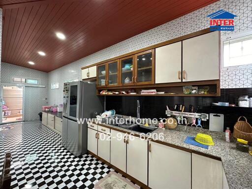 Modern kitchen with checkerboard flooring and ample storage