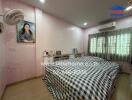 Bedroom with a double bed, checkered bedding, and pink wallpaper