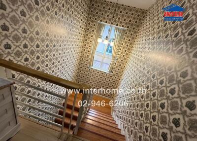 Stylish staircase with patterned wallpaper