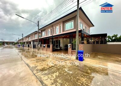 Exterior view of townhouses on a rainy day