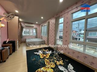 Spacious bedroom with large windows and double bed