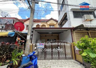 Exterior view of residential building with a front garden and garage