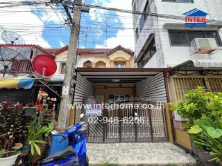 Exterior view of residential building with a front garden and garage