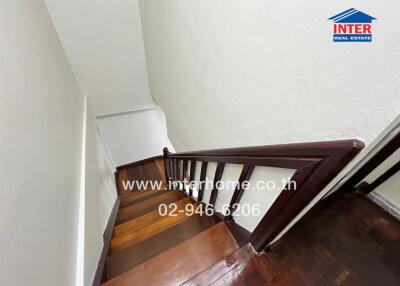 Wooden staircase with white walls