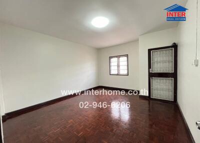 Empty room with wooden floor and a window