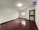 Empty room with wooden floor and a window