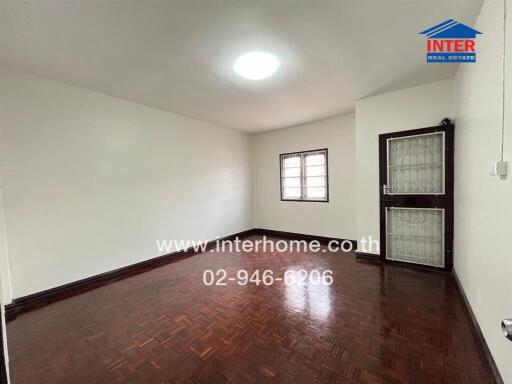 Empty room with wooden floor and a window