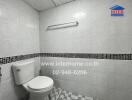 Bathroom with white tiles and toilet