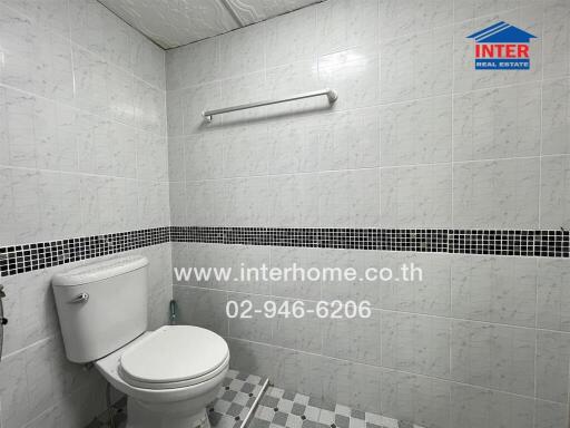 Bathroom with white tiles and toilet