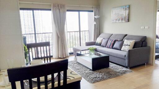 Modern living room with sofa, coffee table, and large windows