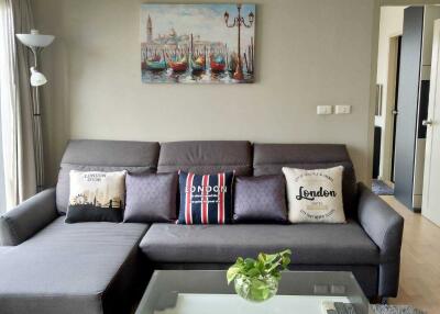 Cozy living room with gray sofa and wall art